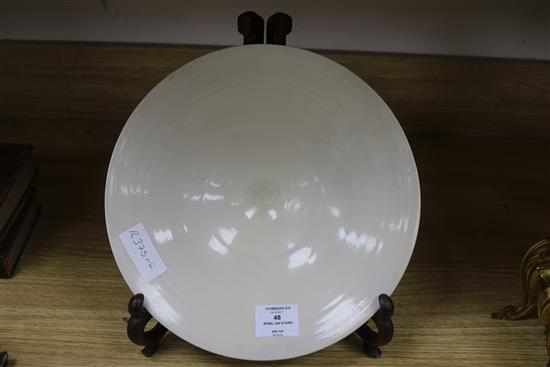 A Chinese cream glazed bowl on stand